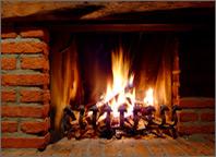Photo of a fire in a brick fireplace. Copyright Malms.